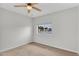 Bedroom with neutral carpet, ceiling fan, and a window allowing natural light at 4102 W Golden Ln, Phoenix, AZ 85051