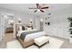 Serene bedroom featuring a ceiling fan and plush bedding, creating a comfortable and stylish retreat at 4102 W Golden Ln, Phoenix, AZ 85051