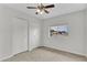 Bedroom featuring carpet, a window view, ceiling fan, and double closets at 4102 W Golden Ln, Phoenix, AZ 85051