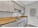Updated kitchen features sleek cabinetry, wood countertops, and stainless steel dishwasher at 4102 W Golden Ln, Phoenix, AZ 85051