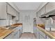 Bright kitchen with stainless steel appliances, wood countertops, and a door leading to the backyard at 4102 W Golden Ln, Phoenix, AZ 85051