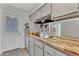Clean kitchen with wood countertops, stainless oven, and a view to the backyard through sliding doors at 4102 W Golden Ln, Phoenix, AZ 85051