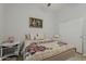 Charming bedroom with a comfortable bed, decorative pillows, artwork, and a closet for ample storage space at 43319 W Oakland Ct, Maricopa, AZ 85138