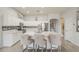 Stylish kitchen featuring white cabinets, stainless steel appliances, and a large island with seating at 43319 W Oakland Ct, Maricopa, AZ 85138