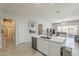 Spacious open kitchen with a large center island, modern appliances, and access to living area at 43319 W Oakland Ct, Maricopa, AZ 85138