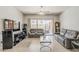 Spacious living room with sliding glass doors to backyard and neutral tile floors at 43319 W Oakland Ct, Maricopa, AZ 85138