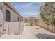Low-maintenance side yard with a paved walkway and gravel landscaping, offering a clean and functional outdoor space at 43319 W Oakland Ct, Maricopa, AZ 85138