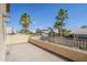 Outdoor balcony with tan stucco railing overlooking the neighborhood and mature palm trees under a bright blue sky at 4353 W Walton Way, Chandler, AZ 85226