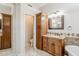 Bathroom featuring custom vanity and cabinets with access to the toilet room at 4353 W Walton Way, Chandler, AZ 85226
