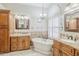 Bathroom featuring dual vanities, a soaking tub, and custom cabinets at 4353 W Walton Way, Chandler, AZ 85226