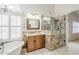 Bathroom featuring granite countertops, glass shower and a soaking tub at 4353 W Walton Way, Chandler, AZ 85226