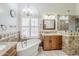 Elegant bathroom featuring a soaking tub, and custom vanity at 4353 W Walton Way, Chandler, AZ 85226