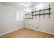 Neutral toned bedroom with wood look flooring and open shelving at 4353 W Walton Way, Chandler, AZ 85226