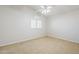 Bedroom with neutral carpet, ceiling fan and white shutters on the window at 4353 W Walton Way, Chandler, AZ 85226