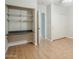 Laminate floored room with built in shelving and a view to a door and closet at 4353 W Walton Way, Chandler, AZ 85226