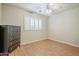 Well-lit bedroom featuring laminate floors, ceiling fan, dresser and window with white shutters at 4353 W Walton Way, Chandler, AZ 85226