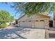 Front exterior view showcases a three car garage, neutral stucco and blue skies at 4353 W Walton Way, Chandler, AZ 85226