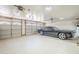 Spacious three-car garage with ample storage space and a black car at 4353 W Walton Way, Chandler, AZ 85226