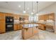 Spacious kitchen featuring custom cabinets, granite countertops, and modern appliances at 4353 W Walton Way, Chandler, AZ 85226