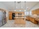 Well-equipped kitchen with a granite island, stainless steel appliances, and warm wood cabinetry at 4353 W Walton Way, Chandler, AZ 85226