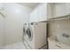 Bright laundry room with modern washer and dryer, white cabinets and utility sink at 4353 W Walton Way, Chandler, AZ 85226