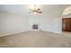Spacious living room featuring a fireplace, high ceilings, and carpeted floors at 4353 W Walton Way, Chandler, AZ 85226