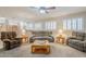 Open living area featuring neutral decor, a ceiling fan, and plantation shutters for ample natural light at 4353 W Walton Way, Chandler, AZ 85226