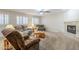 Comfortable living room with neutral carpet, fireplace, and large windows with plantation shutters at 4353 W Walton Way, Chandler, AZ 85226