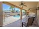 Relaxing covered patio with ceiling fans overlooking the pool and backyard oasis at 4353 W Walton Way, Chandler, AZ 85226