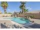 Lush backyard showcasing a sparkling pool with a rock waterfall feature and well-manicured landscaping at 4353 W Walton Way, Chandler, AZ 85226