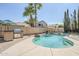 Private backyard pool with rock waterfall feature, barbecue island, and lush palm tree landscaping at 4353 W Walton Way, Chandler, AZ 85226