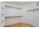 White walk-in closet with wood shelving at 4353 W Walton Way, Chandler, AZ 85226