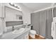 Well-lit bathroom with white vanity, framed mirror, and shower with curtain at 4599 N 17Th Ave, Phoenix, AZ 85015