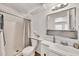 Updated bathroom features white vanity, shower with curtains and modern fixtures at 4599 N 17Th Ave, Phoenix, AZ 85015