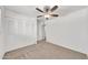 Bright bedroom with neutral carpet, ceiling fan, and closet doors at 4599 N 17Th Ave, Phoenix, AZ 85015