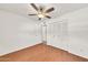 Bright bedroom featuring a ceiling fan, wood-look flooring, and double closet doors for storage at 4599 N 17Th Ave, Phoenix, AZ 85015