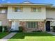 Charming townhome featuring a well-manicured lawn, classic brick accents, and a welcoming front entrance at 4599 N 17Th Ave, Phoenix, AZ 85015