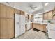 Functional kitchen featuring bright wood cabinetry, a white refrigerator, and a ceiling fan at 4599 N 17Th Ave, Phoenix, AZ 85015