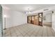 Bright living area features a tiled floor and wooden built-in shelving unit at 4599 N 17Th Ave, Phoenix, AZ 85015