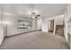 Bright living room boasts soft carpet, fan, natural light, and staircase at 4599 N 17Th Ave, Phoenix, AZ 85015