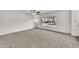 Open living room features plush carpeting, ceiling fan, and large window at 4599 N 17Th Ave, Phoenix, AZ 85015