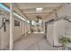 Charming covered patio featuring skylight, ceiling fan, concrete floors, and white picket walls with plants and decor at 4599 N 17Th Ave, Phoenix, AZ 85015