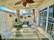 Cozy covered patio with a ceiling fan, stylish white furniture, and a vibrant green rug at 4599 N 17Th Ave, Phoenix, AZ 85015