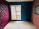 Bedroom features vibrant wallpaper and plantation shutters for natural light at 4727 E Euclid Ave, Phoenix, AZ 85044