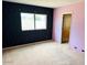 Carpeted bedroom with dark patterned wallpaper and a view from the window at 4727 E Euclid Ave, Phoenix, AZ 85044