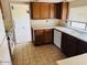 Kitchen with tile flooring, wood cabinets, and appliances, providing a practical and functional space at 4727 E Euclid Ave, Phoenix, AZ 85044