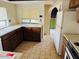 Functional kitchen with tile flooring, wood cabinets, and ample counter space, perfect for everyday cooking at 4727 E Euclid Ave, Phoenix, AZ 85044
