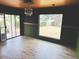 Well-lit living room with wood-look floors and sliding glass doors, offering a view of the backyard at 4727 E Euclid Ave, Phoenix, AZ 85044