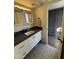 Well-lit bathroom with modern vanity, attractive mirror, and patterned tile flooring at 4727 E Lafayette Blvd # 211, Phoenix, AZ 85018