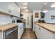 Efficient kitchen featuring butcher block counters, white cabinets, and stainless steel appliances at 4727 E Lafayette Blvd # 211, Phoenix, AZ 85018